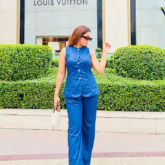 Power dressing is not just about blazers. This structured denim co-ord set is a perfect summer alternative, offering a sharp silhouette with its straight wide-leg pants and darted top, creating a look of effortless authority.