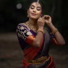 A close-up of the bride-to-be, her traditional jewelry perfectly complementing the rich colors of her saree.