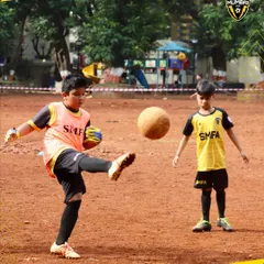 A young player executes a powerful kick during a training drill. We focus on building the fundamentals of tomorrow's champions from the grassroots level.