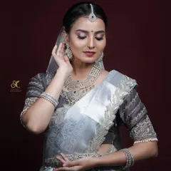 A model poses elegantly during a studio shoot, demonstrating a bridal makeup look. My photography aims to highlight the skill of the makeup artist and the beauty of the model.