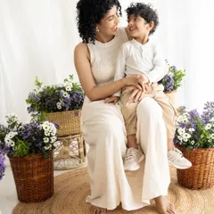 A quiet moment of connection between a mother and her son. The natural light and their gentle interaction create a soft and loving portrait.
