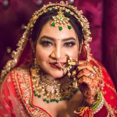 A beautiful close-up of the bride, highlighting her intricate nath (nose ring) and stunning makeup. We focus on these details to create captivating bridal portraits.