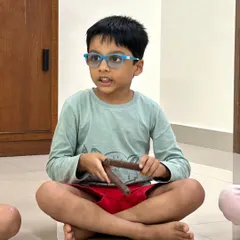 This student is fully engaged, holding claves and looking on as he prepares to play the rhythm pattern in front of him. We teach you how to create a focused yet supportive atmosphere for individual practice.