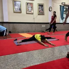 A student achieves a full split, or Hanumanasana, in our class. This level of flexibility is the result of patience, dedication, and proper technique.