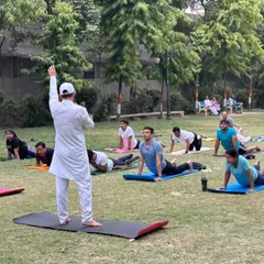 Leading a large outdoor class in Bhujangasana (Cobra Pose). Practicing in nature adds another layer of connection and tranquility to the yoga experience.