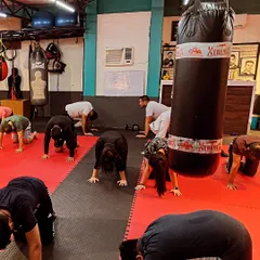 A moment from our warm-down sequence. The entire group moves together, stretching out after a hard workout. This is essential for recovery and preventing injury.