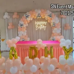 A lovely peach and white balloon arch with a neon sign. This setup is perfect for a small party or as a photo corner, providing an elegant look at an affordable price.