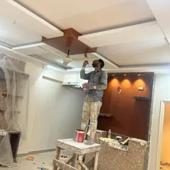 Our painter is giving the final touches to a complex false ceiling. We handle detailed work on multi-level ceilings, ensuring every edge and corner is painted to perfection for a sophisticated look.