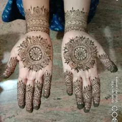 A beautiful floral mandala design on both palms, complemented by detailed patterns on the fingers. This symmetrical look is a timeless choice for any occasion.