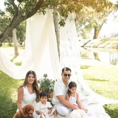 A perfect family photo where even the dogs are posing. This image from a Bangalore park session shows that pets are a key part of the family story.
