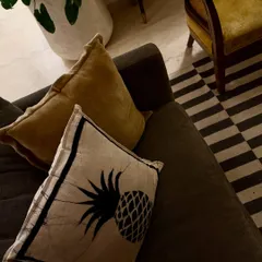 A close-up of the textures in my living room. I love mixing patterns and materials, like this pineapple print cushion against the simple sofa fabric.