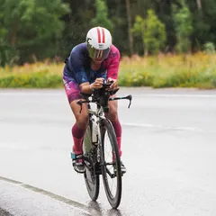 Head down, pushing through the rain and cold on the bike leg in Estonia. My fingers were frozen, affecting gear transitions, but you do the best you can. The work we did on my bike fit was key to managing this tough ride.