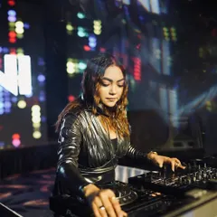 In the zone, carefully selecting and mixing tracks on my Pioneer DJ console.