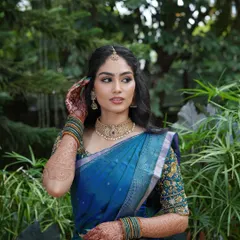 A candid moment captured beautifully. The makeup is designed to look flawless from every angle, with a focus on luminous skin and softly defined eyes.
