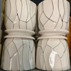 These imported ceramic planters have a distinctive shape and a modern line pattern. Their unique two-tiered appearance makes them a standout piece for any indoor plant collection.