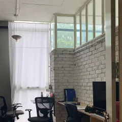 Our studio includes quiet corners and office spaces that support the creative work we do. The design features exposed brick and large windows, creating a bright and inspiring atmosphere.