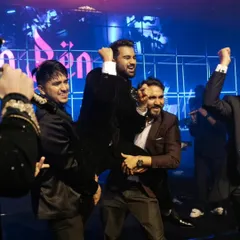 The groom being lifted by his friends in a moment of pure celebration and joy.