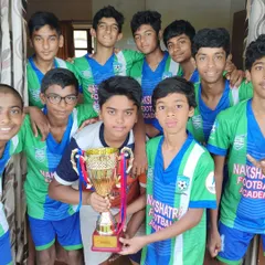The U-15 team proudly holding the winner's trophy after a successful All India tournament in Goa. These moments are what we strive for.
