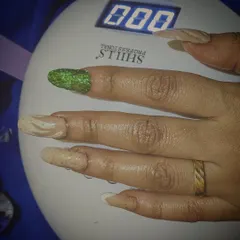 The final set curing under my professional UV lamp. This step ensures the gel polish and extensions are rock-solid and will last for weeks without chipping, locking in the intricate designs.