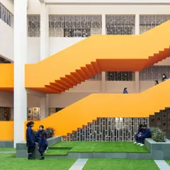 We transform overlooked "in-between" spaces into lively hubs for student interaction. This vibrant orange staircase and multi-level courtyard at SMR Jaipuria School is more than just a way to get from one floor to another; it's a place to pause, connect, and build community.