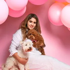 A beautiful family portrait from a birthday shoot, with the owner holding her two adorable dogs against a vibrant pink backdrop. I always encourage hoomans to jump in for a few shots.