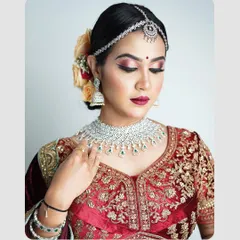A close-up bridal or traditional portrait focusing on the intricate makeup and jewelry. The soft lighting and gentle pose highlight the elegance and grace of the subject, perfect for a beauty or bridal portfolio.