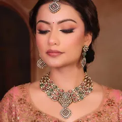 A close-up of the 'Sundar' look. The makeup is soft and ethereal, with a clean winged liner and a natural lip color that perfectly matches the pastel tones of her outfit and jewelry.