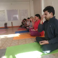 Leading a group class in pranayama, a key part of our practice for stress reduction and mental clarity. I guide students of all levels to connect with their breath in a quiet, focused environment.