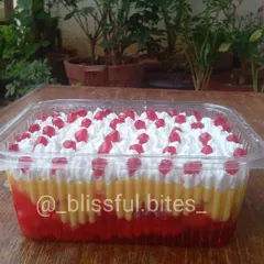 A family-sized portion of my classic fruit trifle, with its colourful layers of jelly and custard, ready for a party.