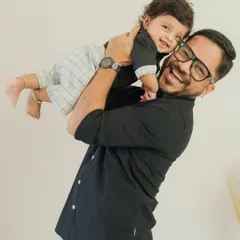 Like father, like son. This joyful portrait captures the special bond between a dad and his mini-me, full of laughter and love.