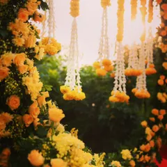A close-up look at the details of our floral decor. Here you can see the delicate combination of white jasmine and yellow marigold strings, which add texture and traditional fragrance to the Haldi setup.