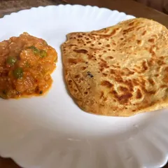 A simple and comforting meal of a plain paratha with a side of baingan bharta. Sometimes the simplest combinations are the most delicious.