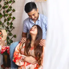 An intimate couple's portrait from a boho-style session. The soft, natural light and the loving gaze they share create a tender and heartfelt memory of their pregnancy journey.