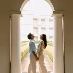 Using grand architecture to frame a simple, sweet moment. This shot from a pre-wedding shoot at Raffles Udaipur captures the couple looking up together, symbolizing their shared dreams and future.