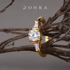 A promise of forever should be as unique as your love story. This bespoke engagement ring features a brilliant-cut centre diamond, flanked by elegant baguette diamonds on a polished 18k gold band. I work with each client to ensure every element, from the diamond's cut to the band's design, perfectly captures their vision.