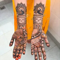 A stunning minimal bridal design. This look features elegant swans on the forearm and a mix of lotus motifs and geometric patterns on the palms.