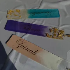 A closer look at the personalized resin bookmarks, showing the details of the gold leaf and color blending.