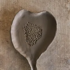 A raw clay leaf dish, with a textured center. This piece is waiting for the fire to transform it, but it already holds so much beauty in its natural, earthy state.