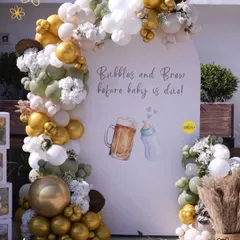 For this "Bubbles and Brew" themed baby shower, we created a fun and stylish balloon arch backdrop. The neutral tones of sage green, white, and gold chrome gave it a sophisticated yet playful vibe, perfect for celebrating the parents-to-be.