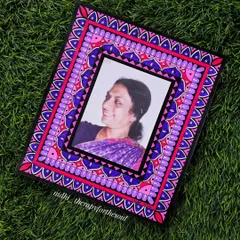 A custom-made souvenir featuring a hand-painted mandala border around a photograph. This is a wonderful way to turn a cherished memory into a unique piece of decorative art.