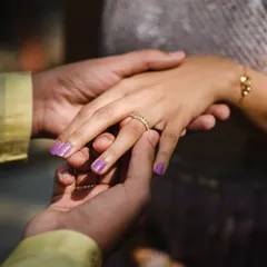 A detailed shot of the bride's hand with her new engagement ring. The focus on the hands and the ring tells a story of the promise just made.