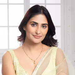 A portrait of the model wearing the delicate gold necklace, capturing a warm and gentle expression. This style of image helps to create an emotional connection with the product.