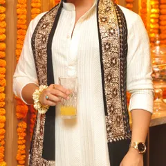 A closer look at the exquisite embroidered stole, which elevates the simple white kurta into a statement outfit. It's all in the details.