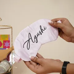 A personalized satin eye mask with the name "Ayushi," a small but thoughtful detail that makes the birthday gift unique.
