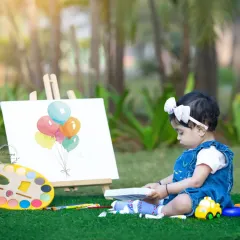 A little artist deeply focused on her work. This shot captures the quiet concentration and creativity of a child's world during one of our themed outdoor sessions.