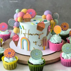 A full view of the Candyland cake, complete with matching cupcakes. Every detail is handcrafted to create a sweet, magical world.