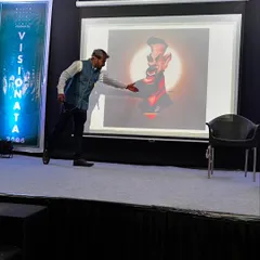 A key part of my guest lectures involves a detailed breakdown of my artistic techniques. Here, I'm presenting one of my digital caricature works, explaining the thought process behind the style, lighting, and expression to a student audience.