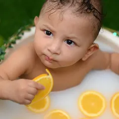 A playful and unique baby photoshoot featuring a fun citrus milk bath. I love creating adorable and memorable portraits of your little ones as they grow.