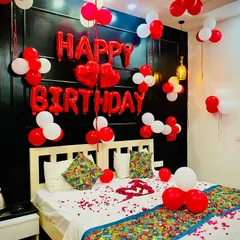 A clean and bright look for a birthday bedroom. The red and white balloons are arranged neatly against a dark headboard, making the "Happy Birthday" message pop.