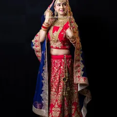 This stunning red lehenga paired with a royal blue velvet dupatta offers a unique and regal combination. We love helping brides find a look that is both traditional and personal.